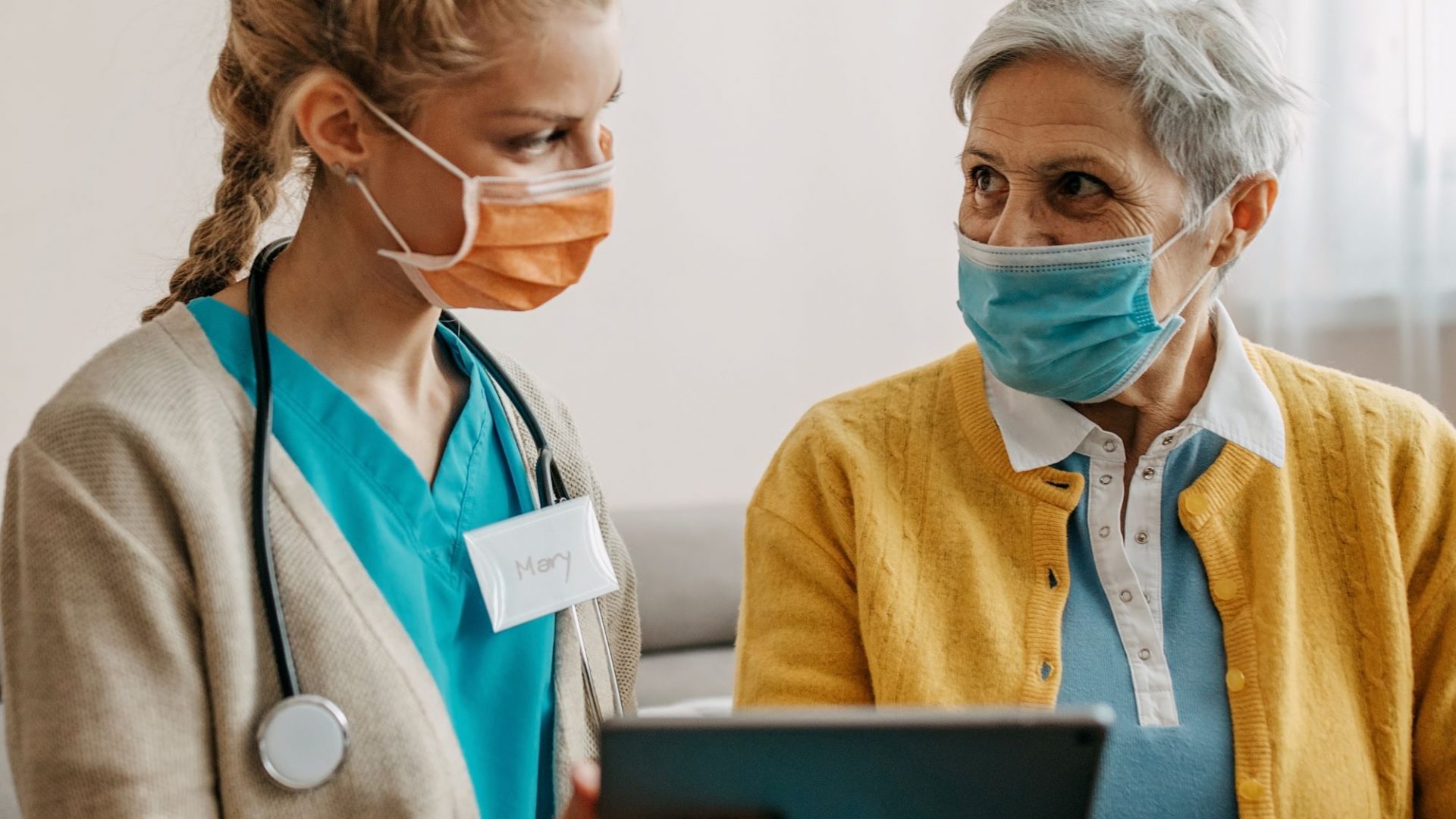 care staff with resident in masks