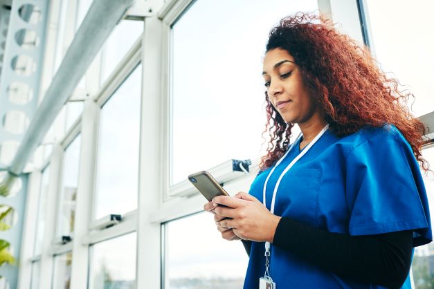 frontline care employee looking at her smartphone